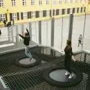 woman in black jacket and black pants standing on round black metal table