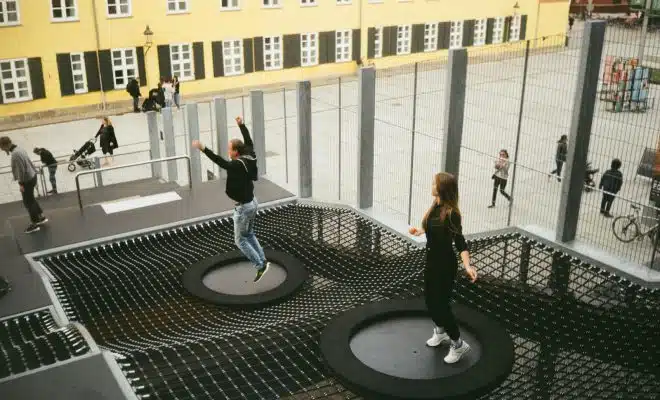 woman in black jacket and black pants standing on round black metal table