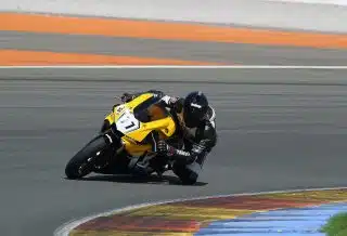 man riding yellow sportbike